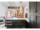 A kitchen island featuring a microwave, drawers, and cabinets, set against an exposed brick wall at 87 Peachtree Sw St # 209, Atlanta, GA 30303