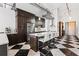 Modern kitchen with a large island, stainless steel appliances, and black-and-white checkered flooring at 87 Peachtree Sw St # 209, Atlanta, GA 30303