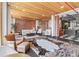 Bright living room with exposed brick, wood ceilings, oversized windows, and access to the adjacent kitchen at 87 Peachtree Sw St # 209, Atlanta, GA 30303