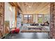 Open living room with wood ceiling, brick accents, and modern fireplace features oversized windows for natural light at 87 Peachtree Sw St # 209, Atlanta, GA 30303