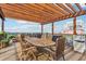 Spacious rooftop deck featuring wood floors, a pergola with string lights, and outdoor seating and grilling area at 87 Peachtree Sw St # 209, Atlanta, GA 30303