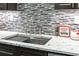 Stylish stainless steel kitchen sink featuring a pull down faucet and modern countertop at 87 Peachtree Sw St # 209, Atlanta, GA 30303