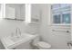 Stylish bathroom with a pedestal sink, modern fixtures, and a window at , Atlanta, GA 30306