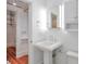Bright bathroom featuring a pedestal sink, modern fixtures, and access to a closet at , Atlanta, GA 30306