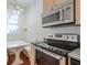 Bright kitchen featuring stainless steel appliances, built-in seating, and hardwood floors at , Atlanta, GA 30306