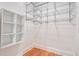 Well-organized walk-in closet with custom shelving and hardwood flooring at , Atlanta, GA 30306