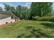 Expansive backyard featuring lush green lawn and mature trees at 145 Devilla Trce, Fayetteville, GA 30214