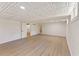 Spacious basement featuring a decorative ceiling and new flooring at 145 Devilla Trce, Fayetteville, GA 30214