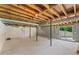 Unfinished basement with concrete floor and exposed wooden ceiling beams at 145 Devilla Trce, Fayetteville, GA 30214
