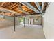 Unfinished basement with concrete floor and exposed wooden ceiling beams at 145 Devilla Trce, Fayetteville, GA 30214