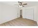 Light-filled bedroom featuring a ceiling fan, closet, and wood-look floors at 145 Devilla Trce, Fayetteville, GA 30214