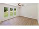 Bright, sun-filled bedroom with sleek wood floors and large windows overlooking the landscaped yard at 145 Devilla Trce, Fayetteville, GA 30214
