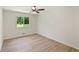 Bedroom featuring wood-look floors and a window overlooking the yard at 145 Devilla Trce, Fayetteville, GA 30214