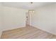 Bright dining room featuring wood-look floors, white walls, and a modern chandelier at 145 Devilla Trce, Fayetteville, GA 30214