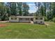 Charming ranch home featuring a lush lawn and mature trees, creating a serene and inviting atmosphere at 145 Devilla Trce, Fayetteville, GA 30214
