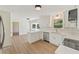 Modern kitchen with white cabinets, quartz countertops, stainless steel appliances, and stylish backsplash at 145 Devilla Trce, Fayetteville, GA 30214