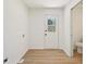 Clean, bright laundry room with a door to the backyard and wood-look flooring at 145 Devilla Trce, Fayetteville, GA 30214