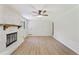Bright and airy living room featuring a whitewashed fireplace, new floors, and ample natural light at 145 Devilla Trce, Fayetteville, GA 30214