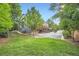 Lush backyard with mature trees and a view of townhome exteriors and garages at 2300 Whiteoak Drive Southeast Se Dr, Smyrna, GA 30080