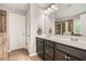 Bathroom with a double sink vanity, large mirror, tile flooring and walk-in shower with glass door at 2300 Whiteoak Drive Southeast Se Dr, Smyrna, GA 30080