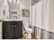 Bathroom featuring modern vanity with a framed mirror, toilet, and white shower curtain at 2300 Whiteoak Drive Southeast Se Dr, Smyrna, GA 30080