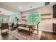 Dining area featuring a wooden table, natural light, and view of the living room at 2300 Whiteoak Drive Southeast Se Dr, Smyrna, GA 30080
