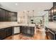 Modern kitchen featuring dark cabinets, granite countertops, stainless steel appliances, and hardwood floors at 2300 Whiteoak Drive Southeast Se Dr, Smyrna, GA 30080
