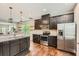 Modern kitchen with stainless steel appliances, dark cabinets, and hardwood floors at 2300 Whiteoak Drive Southeast Se Dr, Smyrna, GA 30080