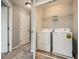 Convenient laundry room featuring a washer, dryer, and overhead shelving for storage at 2300 Whiteoak Drive Southeast Se Dr, Smyrna, GA 30080