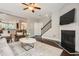 Open-concept living room with hardwood floors, fireplace, and staircase to the second floor at 2300 Whiteoak Drive Southeast Se Dr, Smyrna, GA 30080