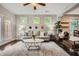 Bright living room featuring stylish furniture, three windows, and a ceiling fan at 2300 Whiteoak Drive Southeast Se Dr, Smyrna, GA 30080
