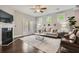 Bright living room featuring stylish furniture, fireplace, and a ceiling fan at 2300 Whiteoak Drive Southeast Se Dr, Smyrna, GA 30080