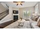 Cozy living room featuring a fireplace, hardwood floors, and a staircase to the second floor at 2300 Whiteoak Drive Southeast Se Dr, Smyrna, GA 30080