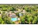 Stunning aerial view of a neighborhood clubhouse, pool, and tennis courts surrounded by lush greenery at 2484 Mossy Branch Dr, Snellville, GA 30078