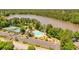 Aerial view of the community amenities, including the pool, tennis courts, and lake at 2484 Mossy Branch Dr, Snellville, GA 30078