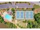Aerial image showcasing the pool, tennis courts, clubhouse, and ample parking within the community at 2484 Mossy Branch Dr, Snellville, GA 30078