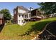 Professionally landscaped backyard boasts a lush lawn, privacy landscaping, a screened porch, and outdoor living space at 2484 Mossy Branch Dr, Snellville, GA 30078