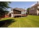 View of a beautifully maintained backyard with a screened porch and deck, perfect for enjoying outdoor living at 2484 Mossy Branch Dr, Snellville, GA 30078