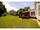 Expansive backyard with lush green lawn, mature trees, deck, and screened porch, perfect for outdoor activities at 2484 Mossy Branch Dr, Snellville, GA 30078