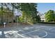 Community basketball court surrounded by mature trees and landscaping at 2484 Mossy Branch Dr, Snellville, GA 30078