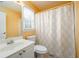 Bright bathroom featuring a shower, toilet and a white vanity with a sink at 2484 Mossy Branch Dr, Snellville, GA 30078