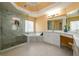 This bathroom is equipped with a glass shower, and double sink with granite countertop at 2484 Mossy Branch Dr, Snellville, GA 30078