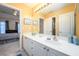 Bathroom featuring a double sink vanity with a view to the bedroom at 2484 Mossy Branch Dr, Snellville, GA 30078