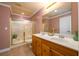 Bathroom featuring double sinks, tile floors, glass shower door, and neutral paint at 2484 Mossy Branch Dr, Snellville, GA 30078