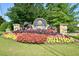 Beautifully landscaped entrance with vibrant flowers welcomes you to Bright Water community at 2484 Mossy Branch Dr, Snellville, GA 30078