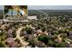 Aerial view of the community featuring amenities like tennis courts and a pool, near a scenic lake at 2484 Mossy Branch Dr, Snellville, GA 30078