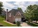 Charming two-story brick home featuring a two-car garage, manicured lawn, and mature trees in a suburban setting at 2484 Mossy Branch Dr, Snellville, GA 30078