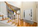 Inviting foyer with hardwood floors, staircase, and view into the living area at 2484 Mossy Branch Dr, Snellville, GA 30078