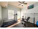 Home gym featuring a treadmill, weight bench, and mirrored wall at 2484 Mossy Branch Dr, Snellville, GA 30078