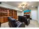 Home theater with a large screen TV, reclining chairs and custom shelving at 2484 Mossy Branch Dr, Snellville, GA 30078